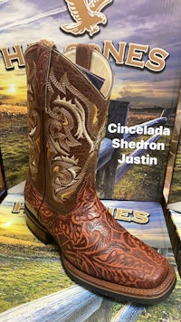 a pair of cowboy boots in front of a box